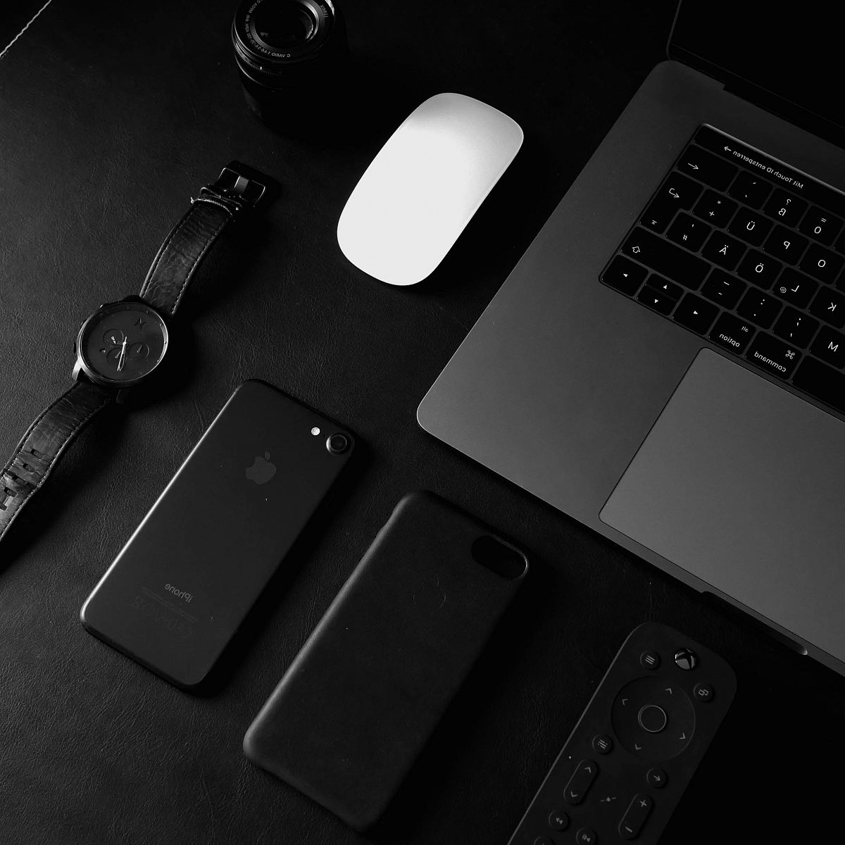jet black iPhone 7 beside analog watch